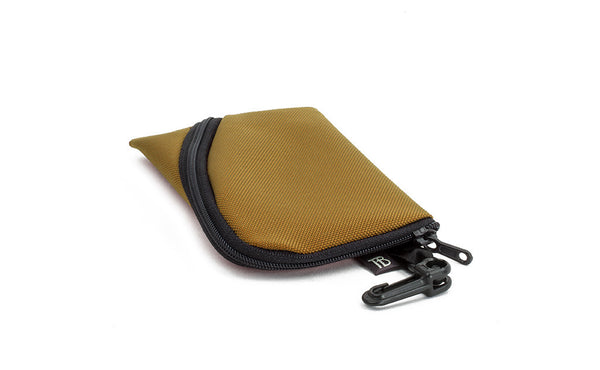 A Mini Ghost Whale Pouch in Coyote (curry brown).
